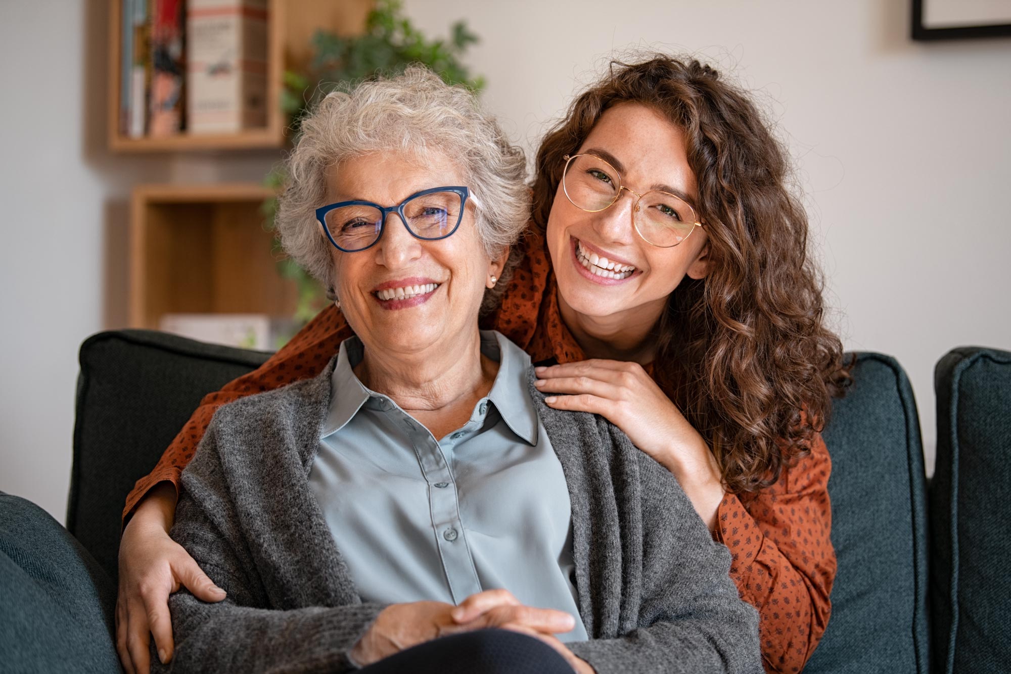 An elderly woman being cared for by a younger woman